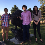 Students James Smith '19, Elliot Schwartz '19, and Jordan Kobbervig '19 standing beside a bison statue.