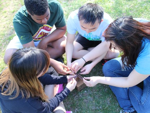 Four TRIO Students solving a puzzle at the 2016 Sophomore Retreat.