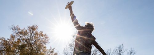 a student leaps in the air to catch a Frisbee