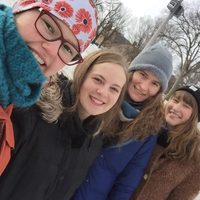 Four female college students at a skating rink