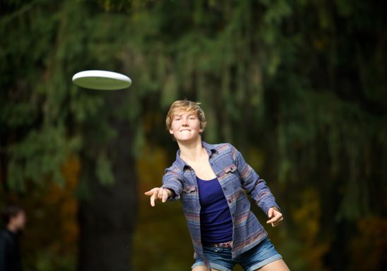 A student tosses a frisbee