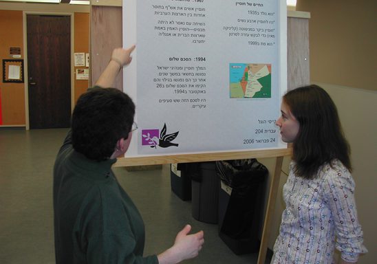 a professor and a student looking at a research poster