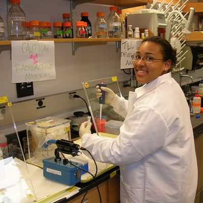 A student performs a chemistry experiment in the lab