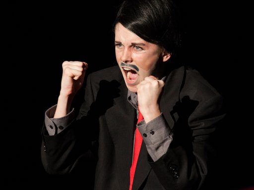 Man yelling with fists raised.