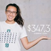 Alysala Malik poses in front of the current campaign total amount: 347.3 million of the 400 million goal